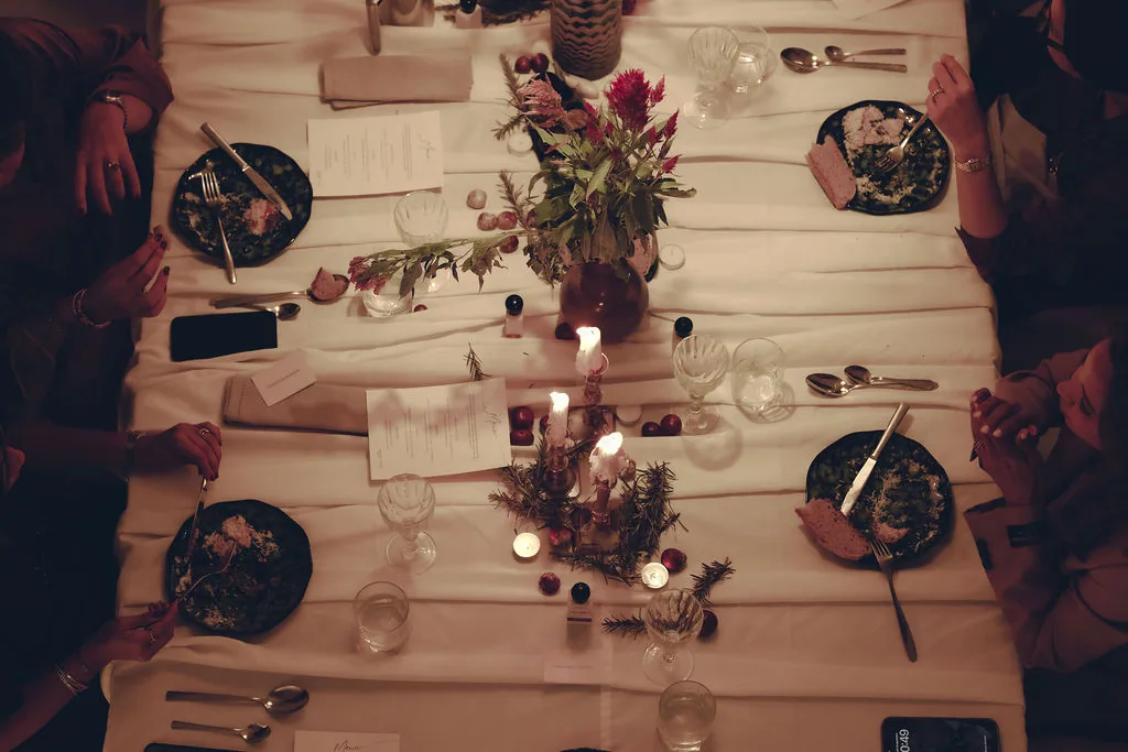 Guests sharing dinner around the table at ANFAS × HALO.